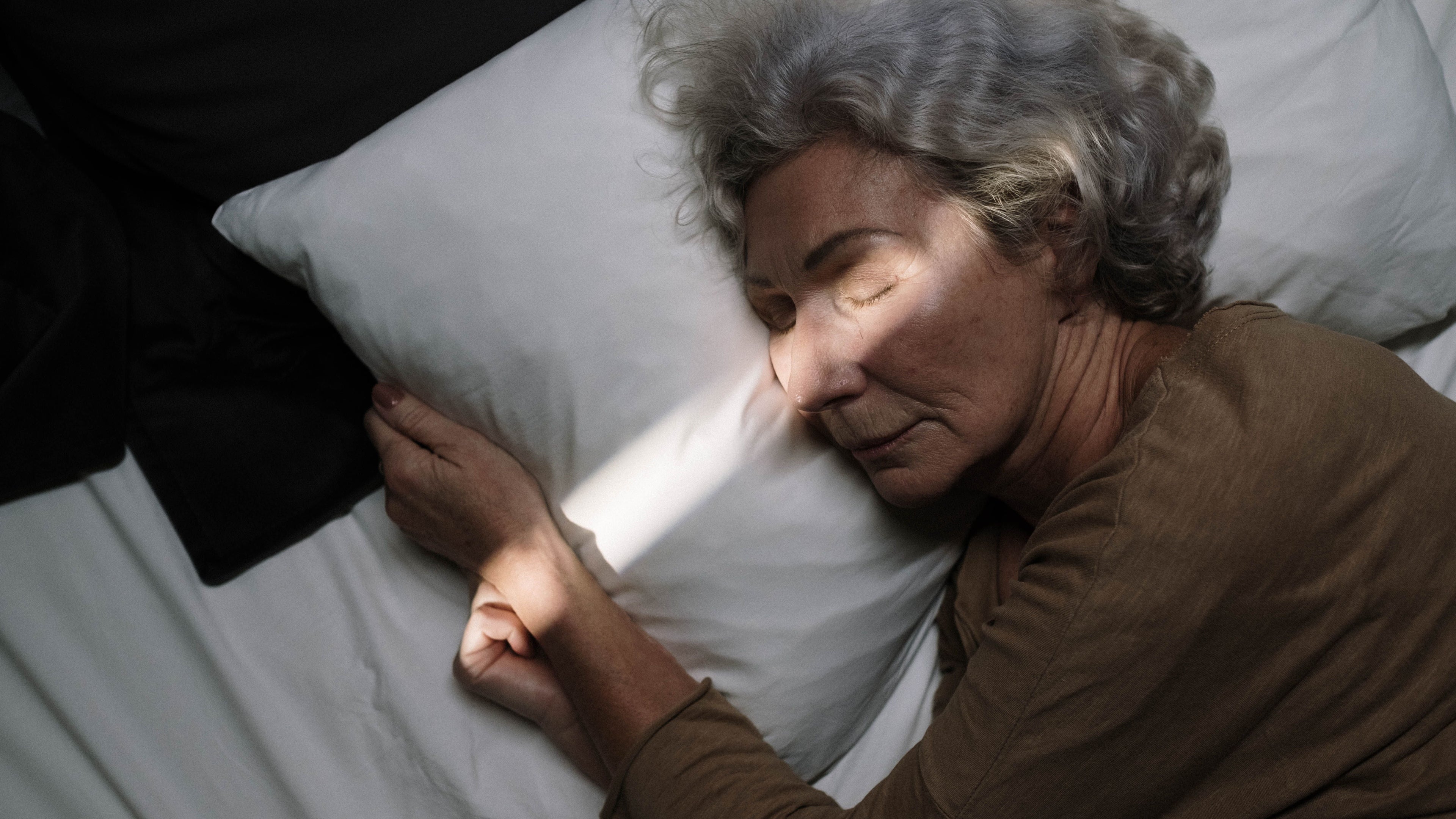 Senior woman sleeping peacefully in bed